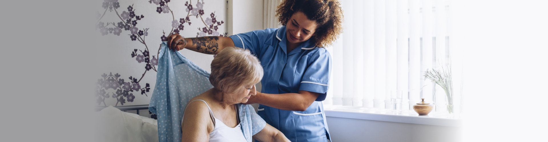 caretaker helping senior woman